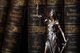 Blind justice figurine in font of old fashioned books [Image by creator Kaspars Grinvalds from AdobeStock]