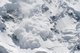 An avalanche of snow falling down a mountain [Image by creator Maygutak from AdobeStock]