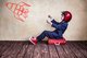 A young boy wearing a blue suit, red high-top sneakers and red helmet, sitting on a suitcase and appearing to ride behind a rocketship [Image by creator Sunny studio from AdobeStock]