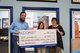 Coast Professional employees holding oversized check showing donation to Louisiana 4-H [Image by creator  from ]